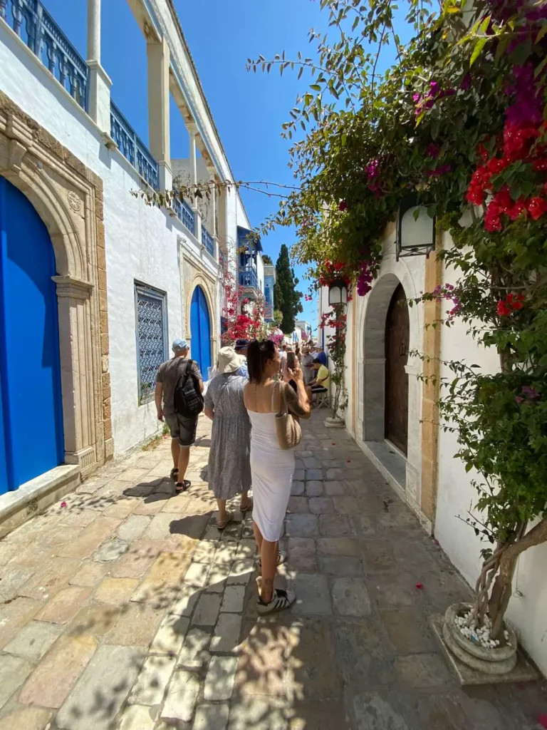 Tourists exploring the blue and white streets of Sidi Bou Said village near Tunis Tunisia