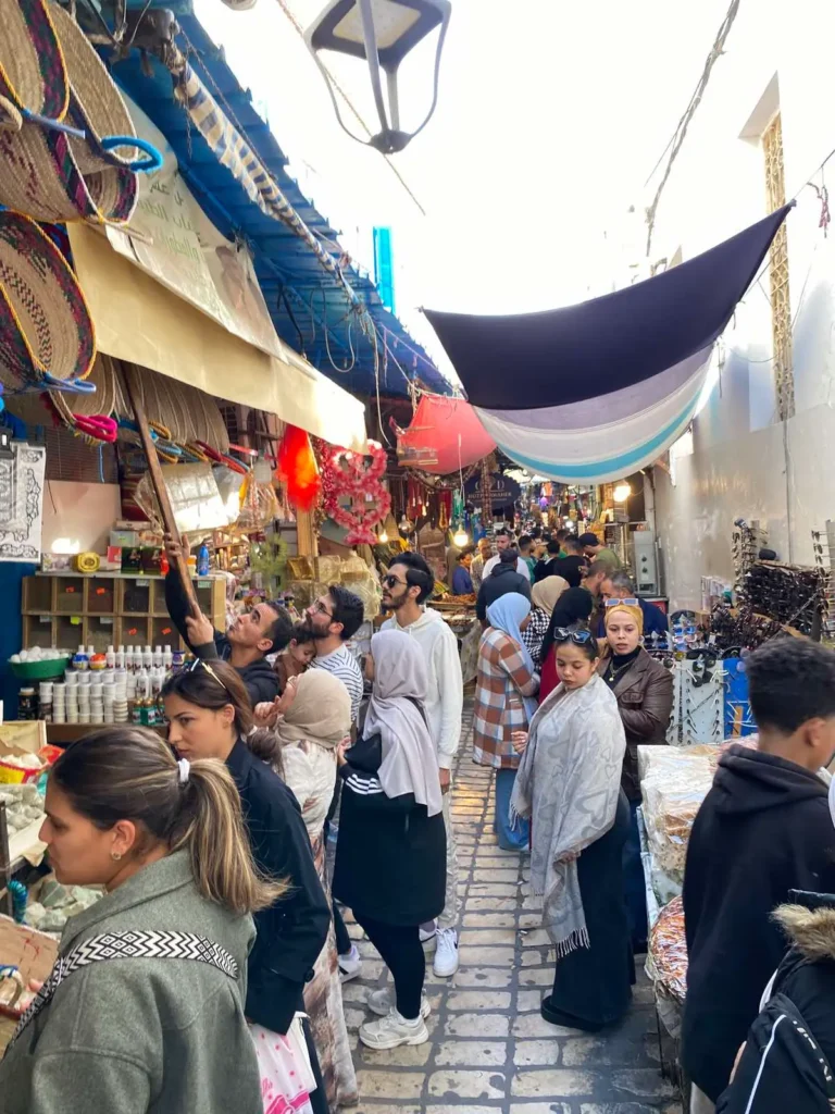 What to buy in Tunisia – crowded Medina of Tunis with tourists and local market stalls