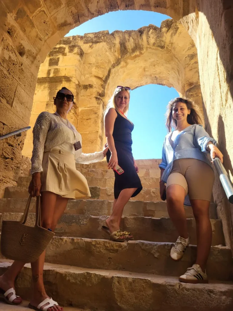 how to get to el jem from sousse visitors walking through el jem amphitheatre stone passage tunisia